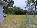 Large backyard area with grass, trees, and a partial view of the home's rear exterior at 1703 Lowder St, Albemarle, NC 28001