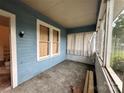 Enclosed front porch with wood plank siding, large windows, and a concrete floor at 1703 Lowder St, Albemarle, NC 28001