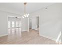 Bright, open living space features hardwood floors and a modern chandelier at 1832 Montclair Ave, Gastonia, NC 28054