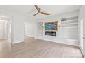 Spacious living room featuring built-in shelves, a ceiling fan, and a decorative fireplace at 1832 Montclair Ave, Gastonia, NC 28054