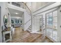 Bright and airy foyer with hardwood floors, staircase, and French doors leading to additional living spaces at 2218 Legacy Oak Dr, Waxhaw, NC 28173