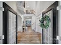 Elegant two-story foyer with hardwood floors, spiral staircase, and decorative chandelier showcases a grand entrance at 2218 Legacy Oak Dr, Waxhaw, NC 28173