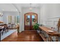 Bright foyer featuring hardwood floors, a decorative chandelier, and a charming wood double-door entryway at 2309 Ethan Way, Weddington, NC 28104