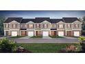 Row of new townhomes showing the exterior facade, well maintained lawns and individual garages at 2927 Penninger Cir, Charlotte, NC 28262