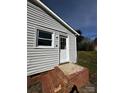 Exterior view of a white door with glass panes and brick stairs at 3048 Marigold Ln, Gastonia, NC 28052
