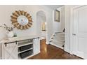 Welcoming entryway boasts hardwood floors, stylish console table and decor, leading to stairs at 3101 Auburn Ave, Charlotte, NC 28209