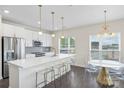Bright kitchen featuring white cabinets, stainless steel appliances, and a modern island with seating at 3630 N Davidson St # 3301, Charlotte, NC 28205