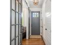 Welcoming foyer with hardwood floors, glass door, sliding door and modern light fixture at 376 Sensibility Cir # 8, Fort Mill, SC 29708