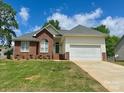 Attractive brick and vinyl home featuring a well-kept lawn and a two-car garage at 3776 Kennedy Rd, Gastonia, NC 28056
