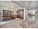 Formal dining room with a large wooden table, elegant chandelier and decorative china cabinet at 397 Fischer Rd, Fort Mill, SC 29715
