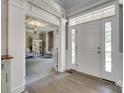 Bright foyer with hardwood floors, white trim, and a glimpse into a cozy living space at 397 Fischer Rd, Fort Mill, SC 29715