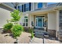 Inviting front door with a blue finish and decorative wreath, framed by elegant landscaping at 397 Fischer Rd, Fort Mill, SC 29715