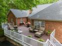 Spacious back deck featuring multiple seating areas, a grill, and views of the lush backyard at 4033 Weddington Manor Ct, Matthews, NC 28104