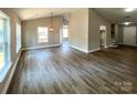 Bright open-concept living area featuring beautiful hardwood floors, neutral walls, and lots of natural light at 4049 Fincher Rd # 3, Matthews, NC 28104