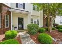 Inviting townhome entrance with well-kept landscaping and a welcoming pathway at 4132 Kenton Glenn Nw Ct, Concord, NC 28027