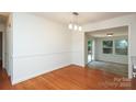 Spacious dining room featuring hardwood floors, trim detail, and an open layout at 4361 Applegate Rd, Charlotte, NC 28209