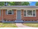 Welcoming front entrance to a brick home with updated trim and a cozy front door at 4553 Morgan St, Charlotte, NC 28208