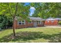 Well-maintained brick home with lush green lawn and trees, offering great curb appeal at 4553 Morgan St, Charlotte, NC 28208