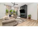 Bright living room with fireplace, ceiling fan, hardwood floors and large glass doors to outside at 4608 Rockwood Dr, Waxhaw, NC 28173