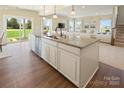 Open-concept kitchen island with sink, dishwasher, and hardwood flooring, perfect for entertaining at 511 Lenswood Ct, Denver, NC 28037