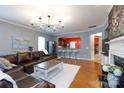 Open living room boasts hardwood floors, stylish lighting, and seamless access to the kitchen at 52538 Winchester St, Fort Mill, SC 29707
