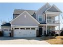 Beautiful two-story home with light gray siding, a two-car garage, and a covered porch at 6176 Russo Ct, Lancaster, SC 29720