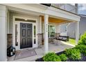 Inviting front porch with a swing, stone pillars, and a wooden ceiling at 6176 Russo Ct, Lancaster, SC 29720