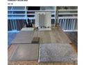 A selection of flooring, countertop, and backsplash samples in neutral tones for home design at 6888 Wilson Creek Dr, Indian Land, SC 29707