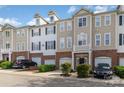 Exterior view of several multi-story townhomes with garages, siding, and brick at 6912 Park Place Dr, Charlotte, NC 28262