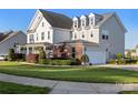 A two-story home with a white garage door and a lush green lawn at 7216 Old Valley Way, Harrisburg, NC 28075