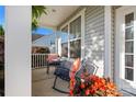 Cozy front porch with rocking chair and table, perfect for relaxing outdoors at 7216 Old Valley Way, Harrisburg, NC 28075