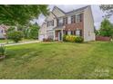 A charming two-story home with a well-maintained lawn and garden, showcasing classic suburban appeal at 8709 Barrelli Ct, Charlotte, NC 28277