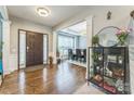Inviting foyer with hardwood floors, elegant pillars, and a view into the adjacent dining area at 8709 Barrelli Ct, Charlotte, NC 28277