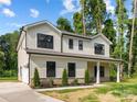 Inviting two-story home with attached garage, neutral siding, and well-manicured landscaping at 8717 Lawyers Rd, Charlotte, NC 28227