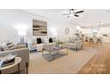 Bright, open-concept living room featuring neutral decor, modern furniture, and hardwood floors at 8717 Lawyers Rd, Charlotte, NC 28227