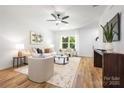 Comfortable living room with neutral color palette, stylish furnishings, and hardwood flooring at 8717 Lawyers Rd, Charlotte, NC 28227