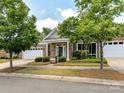 Attractive brick home showcasing well-kept landscaping and a covered entryway with supporting columns at 10727 Ryan Courtney Sq, Mint Hill, NC 28227