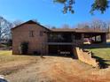 Back exterior of brick home with a covered carport and balcony at 1074 25Th Ne St, Hickory, NC 28601