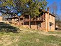 Side view of brick home with a balcony and a grassy yard at 1074 25Th Ne St, Hickory, NC 28601
