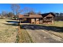 View of brick home featuring a covered carport, second story balcony, and long driveway at 1074 25Th Ne St, Hickory, NC 28601