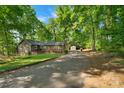 Inviting single story home with a private driveway, lush landscaping, and a storage shed in the backyard at 110 Lakeland Rd # 19, Mooresville, NC 28117