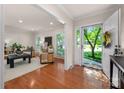 Bright living room with hardwood floors, white trim, and lots of natural light streaming through the windows at 1260 Piccadilly Dr, Charlotte, NC 28211