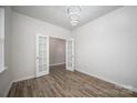 Bright living room with hardwood floors, French doors, and modern light fixture at 150 Falls Cove Dr, Troutman, NC 28166