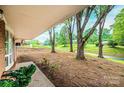 Scenic front yard featuring mature trees and landscaping as seen from the covered porch at 1521 19Th Sw St, Hickory, NC 28602
