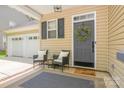 Cozy front porch with seating, decor, and a view of the garage at 17219 Grand Central Way, Cornelius, NC 28031