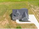 Aerial view of a gray home showing the roof, front porch, driveway, and landscaped yard at 175 Lone Pine Rd, Statesville, NC 28625
