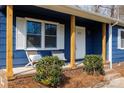 Covered porch with brick base and comfy chairs offers a place to relax at 1757 Ashcroft Ln, Rock Hill, SC 29732