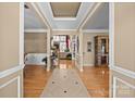 Inviting foyer with hardwood floors and elegant trim work, offering a view of the living spaces beyond at 1900 Birchbrook Ct, Harrisburg, NC 28075