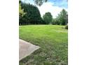 Expansive green backyard surrounded by lush trees offering serene outdoor space at 2030 Keisler Dairy Rd, Conover, NC 28613