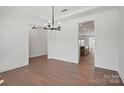 Dining room boasts hardwood floors, white walls, chandelier, and an open view to the kitchen, creating a modern feel at 2176 Millennium Dr # 093, Lancaster, SC 29720